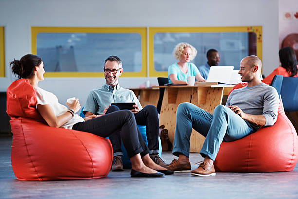 It's a relaxed office Full length shot of businesspeople sitting on beanbag chairs in the officehttp://195.154.178.81/DATA/i_collage/pu/shoots/804606.jpg bean bag stock pictures, royalty-free photos & images