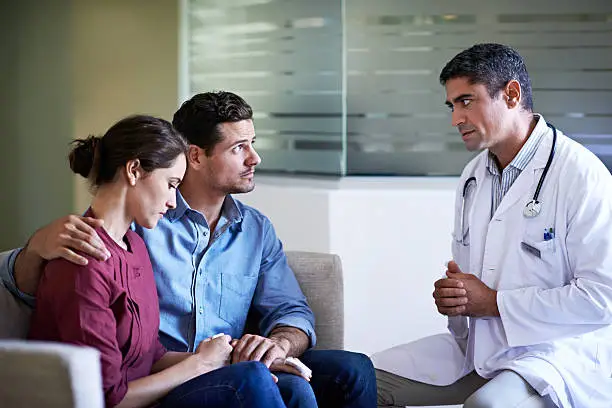 Shot of a doctor giving news to a concerned-looking couple in a hospital waiting roomhttp://195.154.178.81/DATA/i_collage/pu/shoots/804719.jpg