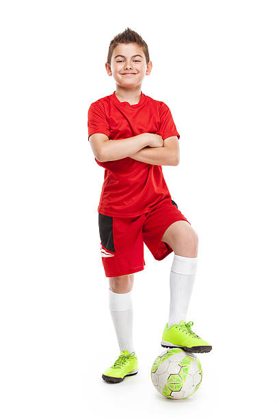 istock standing young soccer player with football 476613668