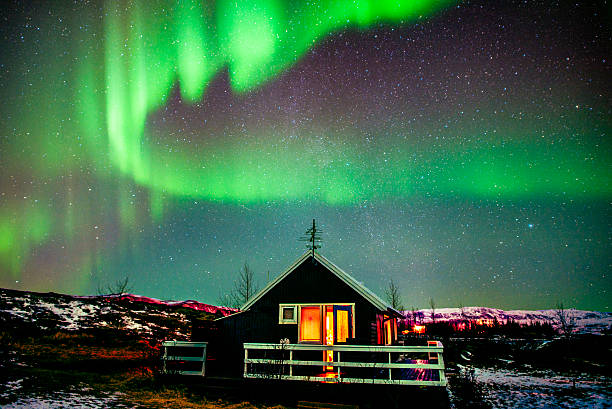 istock Northern Lights visible above small cabin in Iceland 476614420