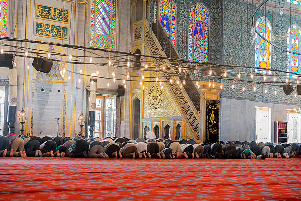 Muslim men at praying Muslim people praying in the Blue Mosque in Istanbul, Turkey. salah islamic prayer photos stock pictures, royalty-free photos & images