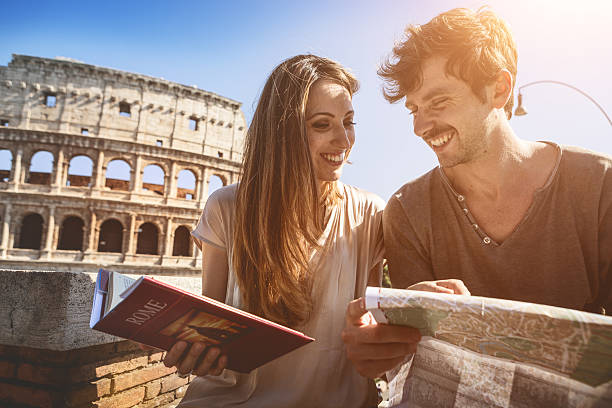 istock Tourists with guide and map in front of the Coliseum 476615254