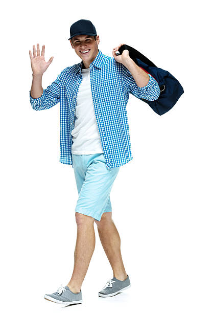 istock Cheerful casual man walking and waving hand 476617936
