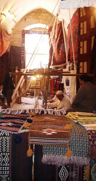 Aleppo bazaar Carpet making at Aleppo bazaar tivoli bazaar stock pictures, royalty-free photos & images