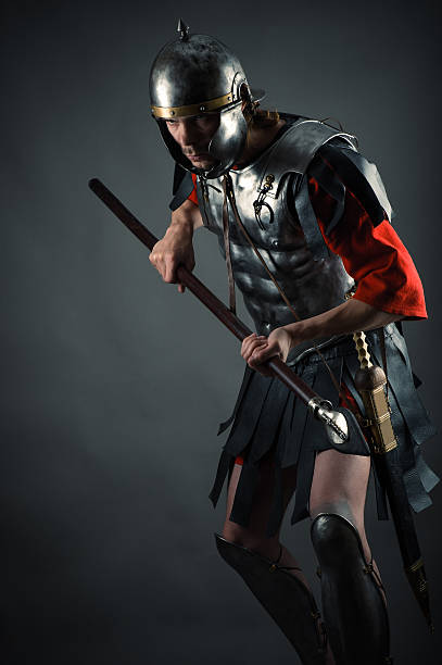 istock brutal warrior in armor with a spear in hands 476618336