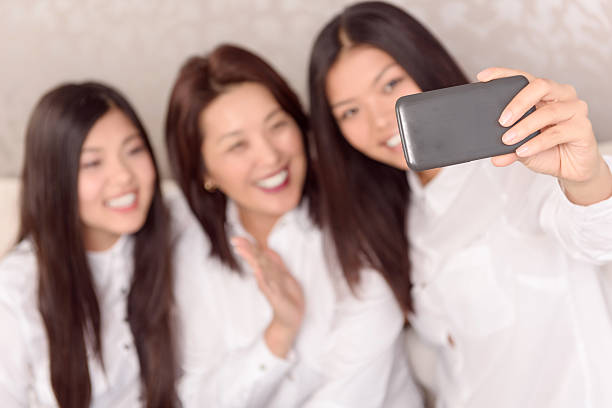 istock Asian girls and there mommy doing selfie 476619328