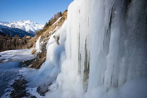 extreme cold in the urtier valley, above the village of cogne, in gran paradiso park, valle d'aosta, italy. some ice cascades and candles