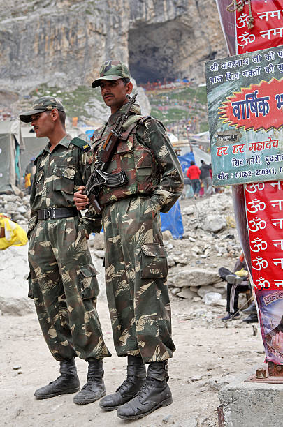 Guards near Holy Amarnath cave Amarnath, Jammu & Kashmir, India - July 18, 2006: Police and security units of Jammu & Kashmir provide security to pilgrims at the holy Amarnath cave in Kashmir Himalayas. Pilgrimage to the holy Amarnath cave in Kashmir Himalayas. Amarnath cave is a Hindu shrine located in Jammu and Kashmir, India. It is dedicated to Shiva. The cave is situated at an altitude of 3,888 m. Amarnath cave shrine is considered to be one of the holiest shrines in Hinduism. Tibetan police stock pictures, royalty-free photos & images
