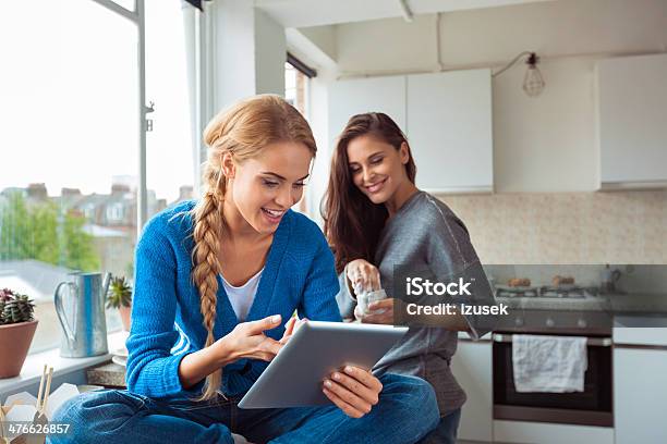 Girl Using Digital Tablet Stock Photo - Download Image Now - Kitchen, Student, Digital Tablet