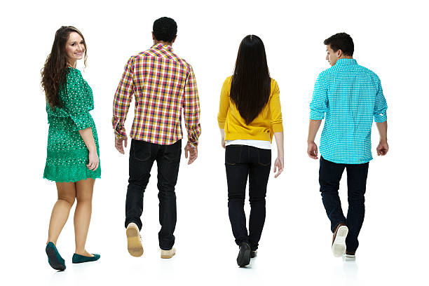 istock Rear view of four friends walking 476628652