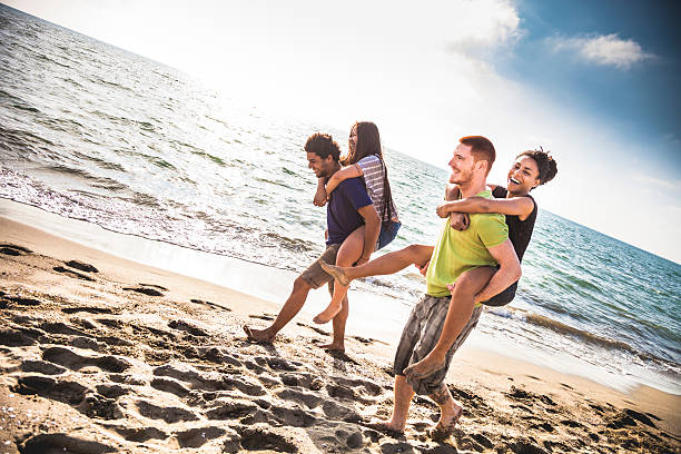 istock Friends playing on the beach in vacation 476631520