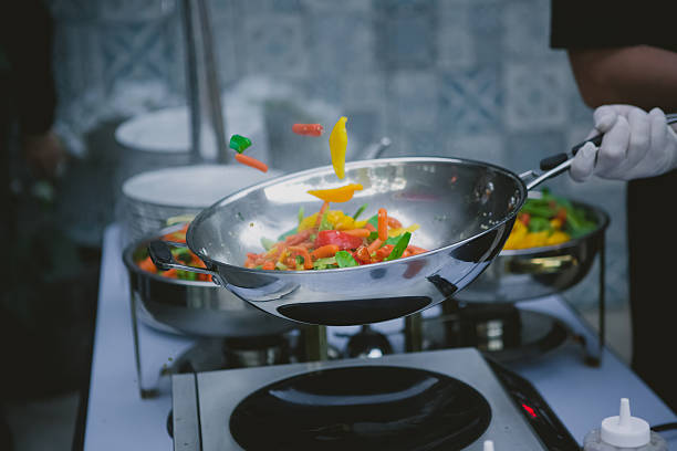 istock cooking vegetables in wok pan 476631566