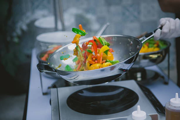istock cooking vegetables in wok pan 476631572