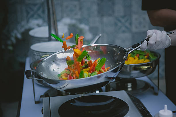 istock cooking vegetables in wok pan 476631574