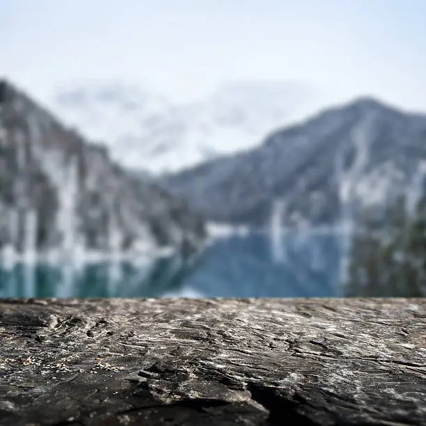 Photo of Winter background. Stone border and defocused landscape on background.