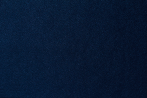 Seamless deep blue leather texture background surface closeup