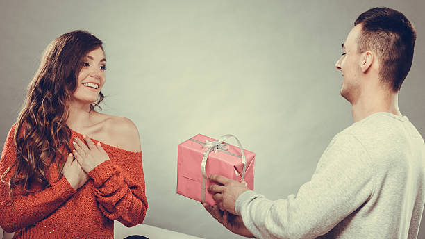 istock happy romantic couple with gift 476633208