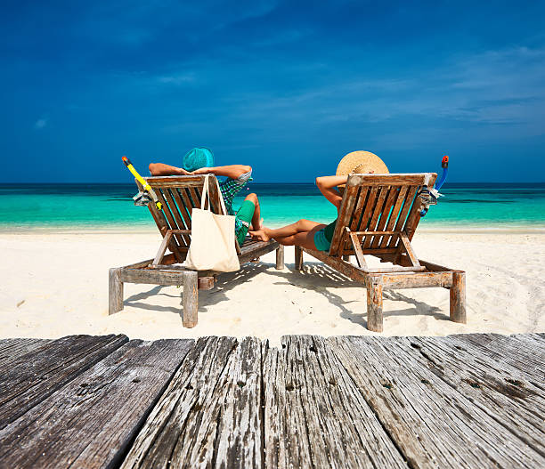 istock Couple in green relax on a beach at Maldives 476641498