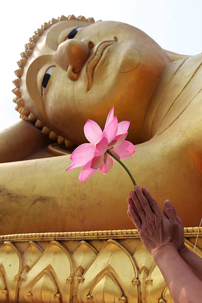 istock hand give resect by lotus flower to buddha image 476646248