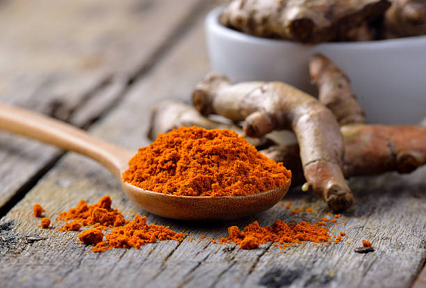 istock pile of fresh turmeric roots on wooden table 476647164