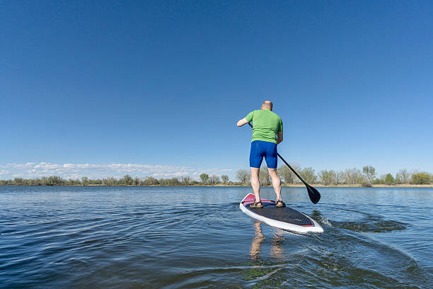 istock stand up paddling on a lake 476650268
