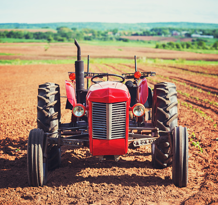 A vintage tractor sits in a freshly turned field in Nova Scotia's Annapolis Valley.