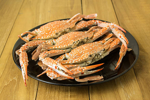 istock crab in black dish on wooden board 476655650
