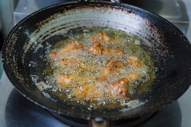 istock cooking fry chicken in boiling oil 476655873