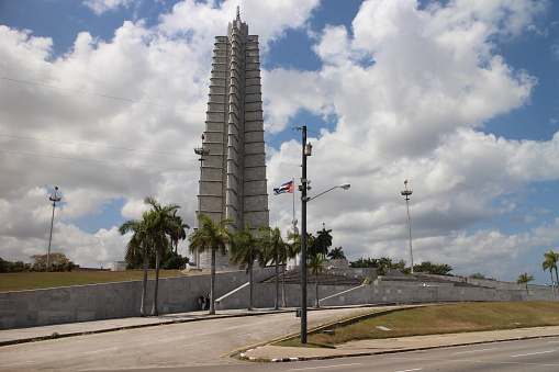 Havana, Сuba - April 7, 2015: The José Martí Memorial (Spanish: Monumento a José Martí) is a memorial to José Martí, a national hero of Cuba, located on the northern side of the Plaza de la Revolución in the Vedado area of Havana. It consists of a star-shaped tower, a statue of Martí surrounded by six columns, and gardens.The 109 m (358 ft) tower, designed by a team of architects led by Enrique Luis Varela, is in the form of a five-pointed star, encased in grey Cuban marble from the Isla de la Juventud. The design was eventually selected from various entries put forward from a series of competitions beginning in 1939.