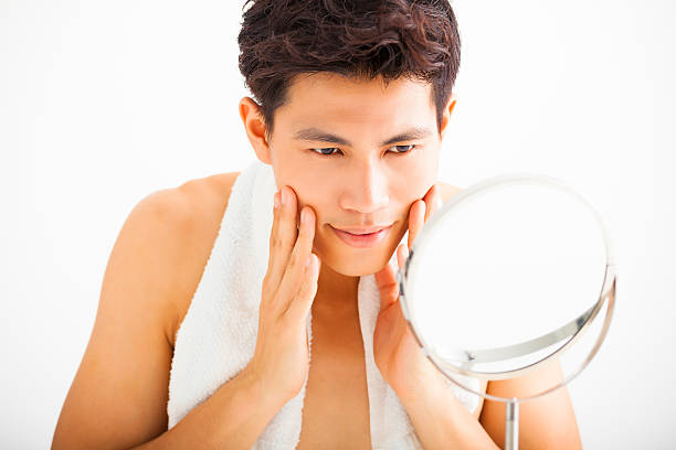 istock Young  man touching his smooth face after shaving 476671866