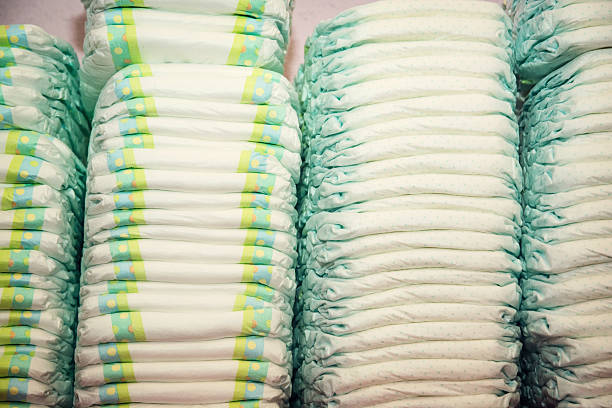 Children's diapers stacked in a many piles stock photo