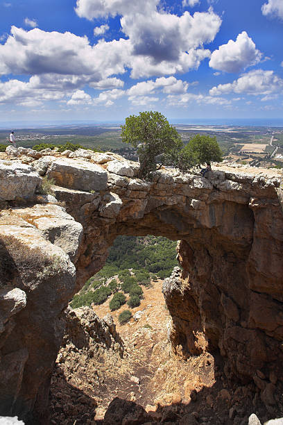 istock Cave and the natural bridge in mountains 476673576