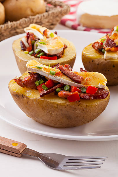 istock Baked potatoes stuffed with bacon, served with camembert 476674592