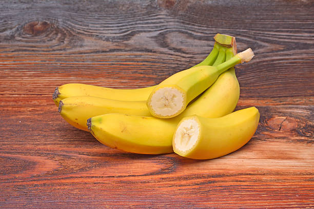 istock Bananas on wooden background 476678094