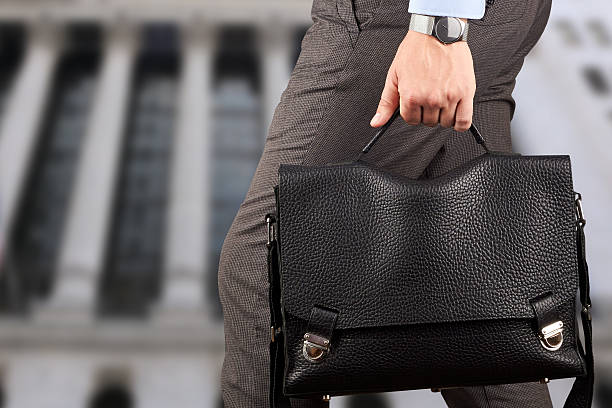 istock Businessman walking and holding  a  leather briefcase in his hand 476679112