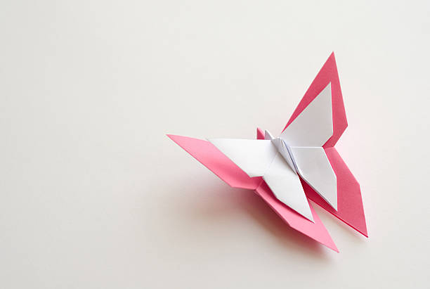 istock Pink origami butterfly on white background 476680712