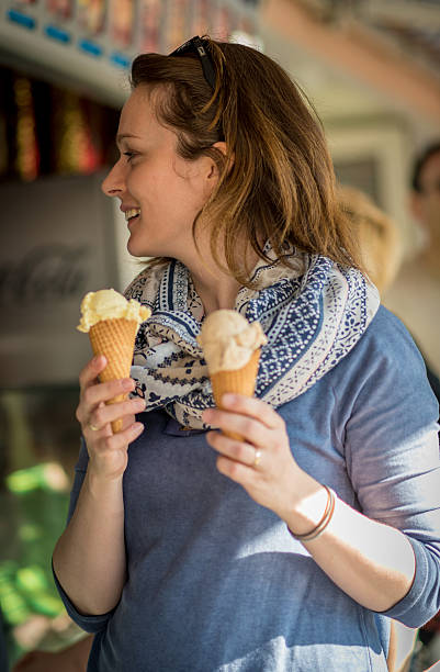 istock Young woman buying ice creams 476685040