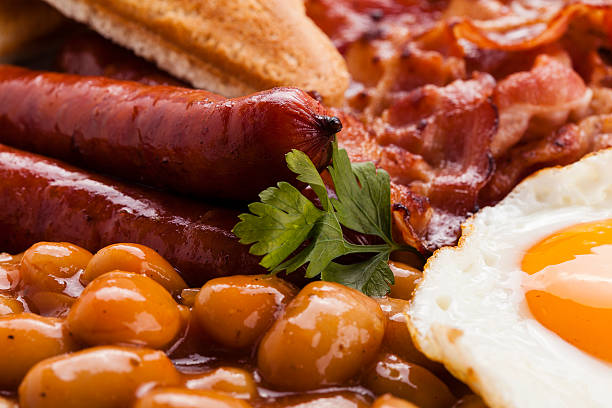 istock Full english breakfast with bacon, sausage, fried egg, baked bea 476688710