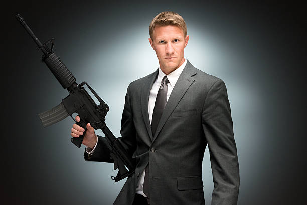 istock Angry businessman holding rifle 476694054