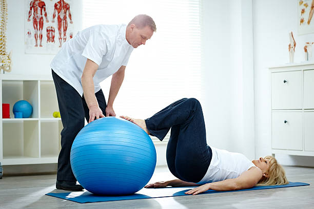 istock Patient doing pilates exercises with physical therapists 476694096