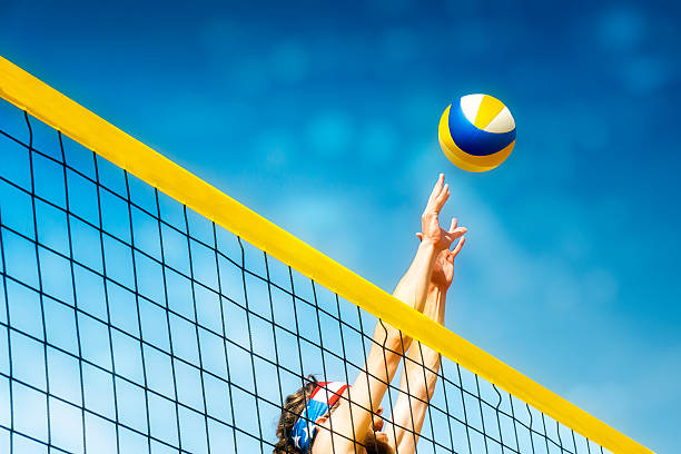 Beach volleyball player net Beachvolley ball player jumps on the net and tries to  blocks the ball volleying stock pictures, royalty-free photos & images