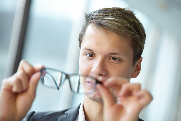 istock young businessman with glasses standing in the hallway 476697532