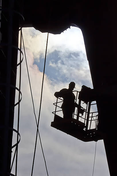 istock Silhouette of builder working at height. Industry 476700082