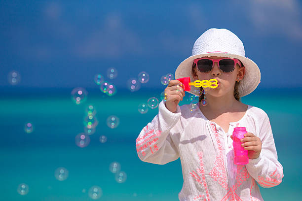 istock Adorable little girl making soap bubbles during summer vacation 476702010