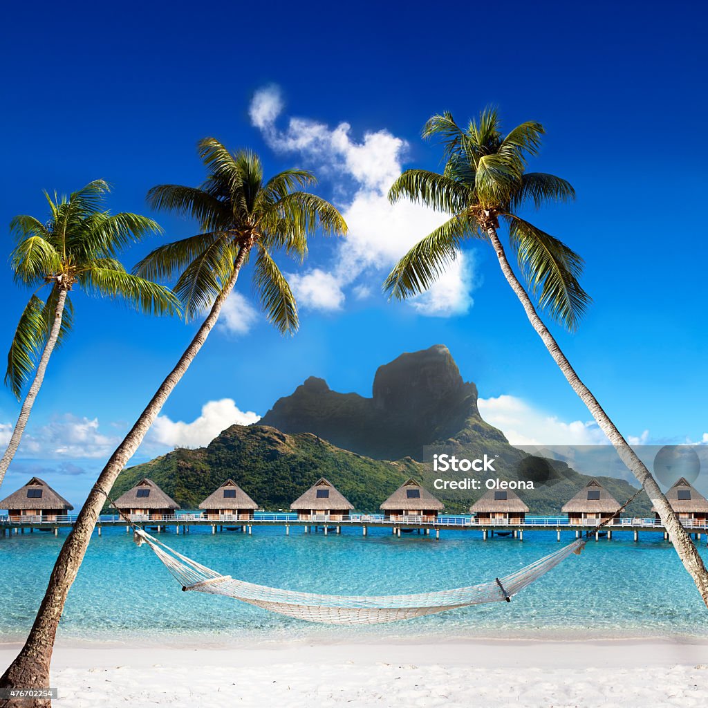 Otemanu mountain  palms with hammock and ocean. Bora-Bora. Polynesia View of the Otemanu mountain through the palms with hammock and ocean. Bora-Bora. Polynesia Bora Bora Stock Photo