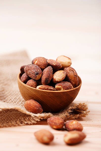 istock almonds in wooden bowl 476702530
