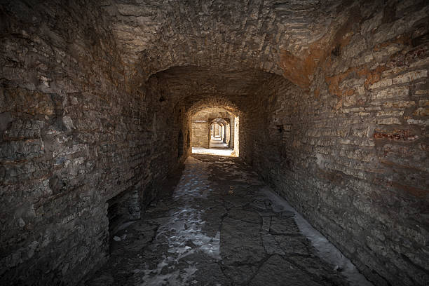 istock Old stone fortress dark tunnel perspective 476703999