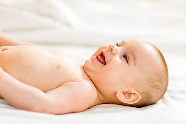 istock Happy cute baby lying down in bed. 476704112