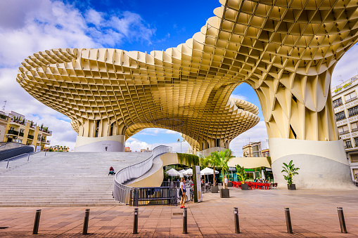 Seville, Spain - November 7, 2014: A Pedestrian passes the Metropol Parasol (by architect Jurgen Mayer H). Located in the old quarter, the structure opened to public controversy in 2011.