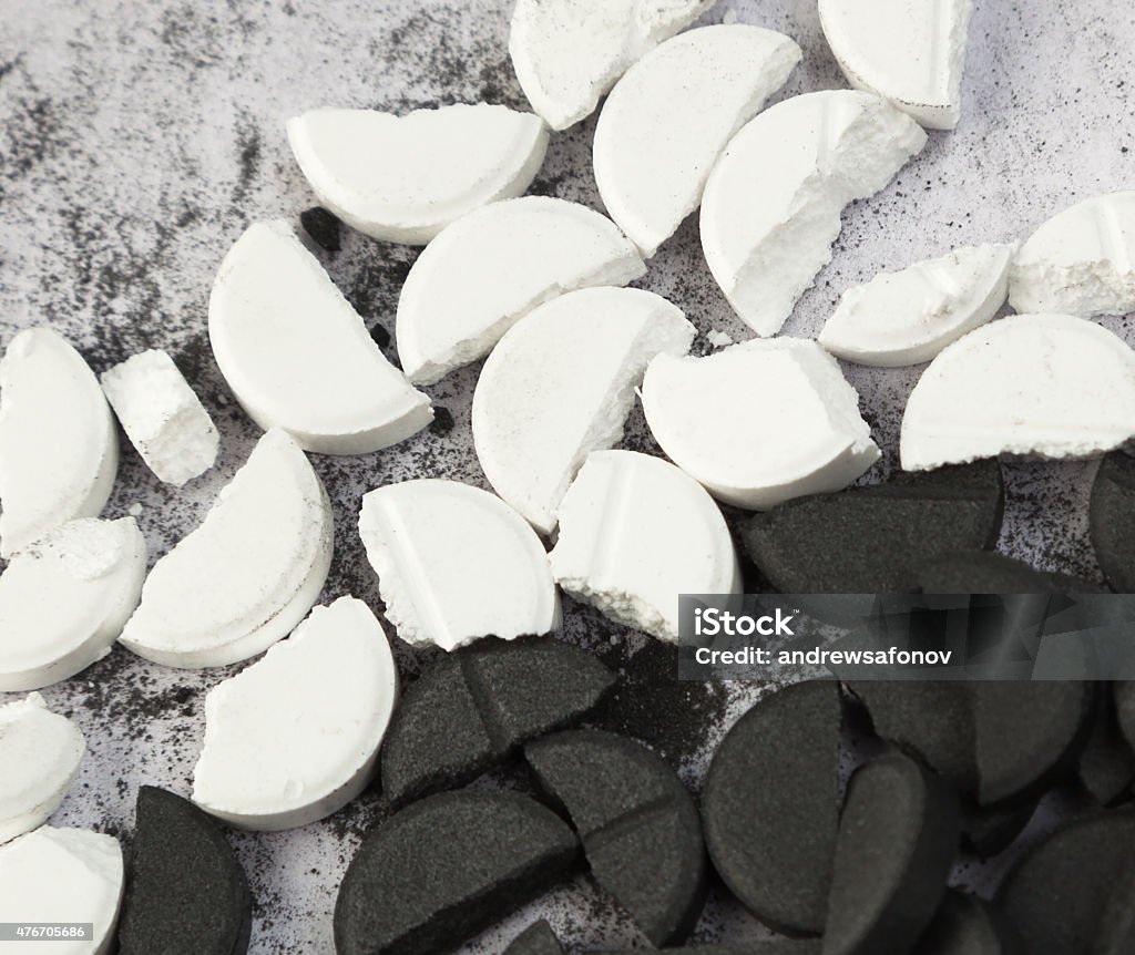 white and black tablets Broken Stock Photo